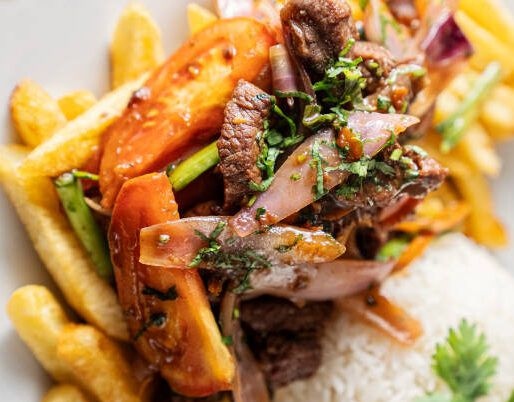 Lomo Saltado (Peruvian Stir-Fried Beef) with french fries, plantain and egg