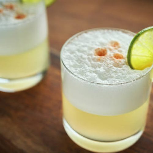 Pisco Sour Cocktail served with Lime